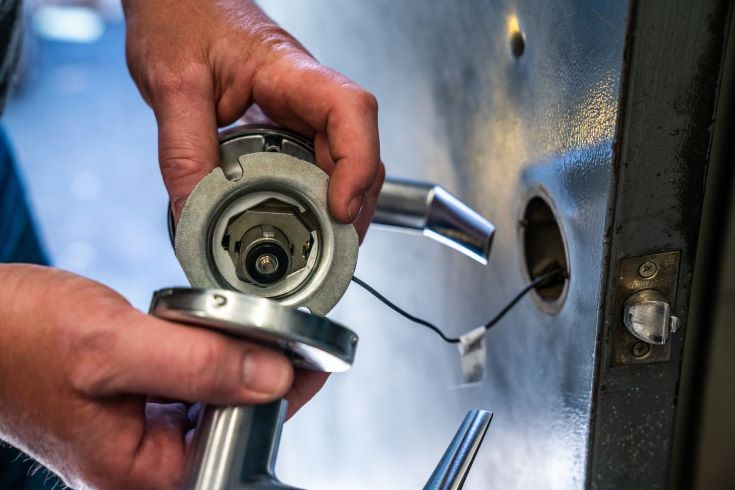 Emergency locksmith technician removing a broken key from a house door lock in Harare